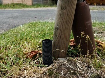 watering pipe at the base of a tree stem